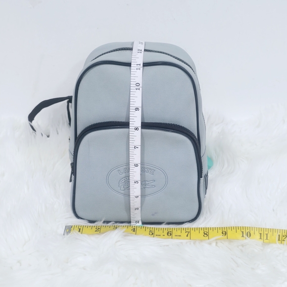 Lacoste mini backpack in a soft light blue shade with navy blue trim accents. - Picture 4 of 16